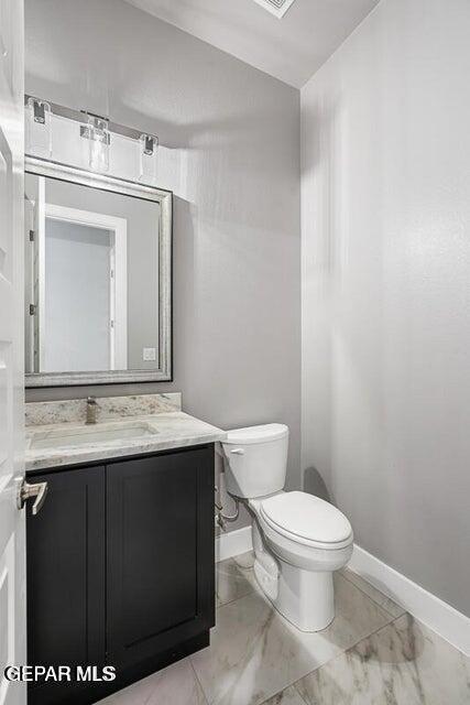 7353 Cimarron Rim Road El Paso, TX 79911 - Photo 3 of 30 a bathroom with a toilet sink and mirror