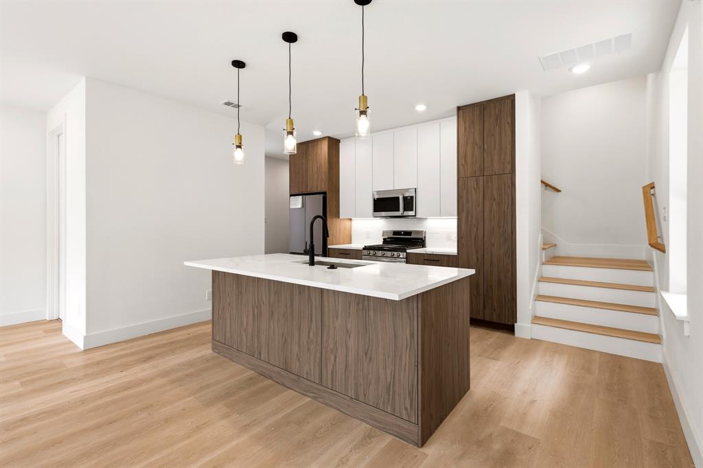 413 North Patton Avenue Dallas, TX 75203 - Photo 1 of 21 a kitchen with kitchen island a sink stove and refrigerator