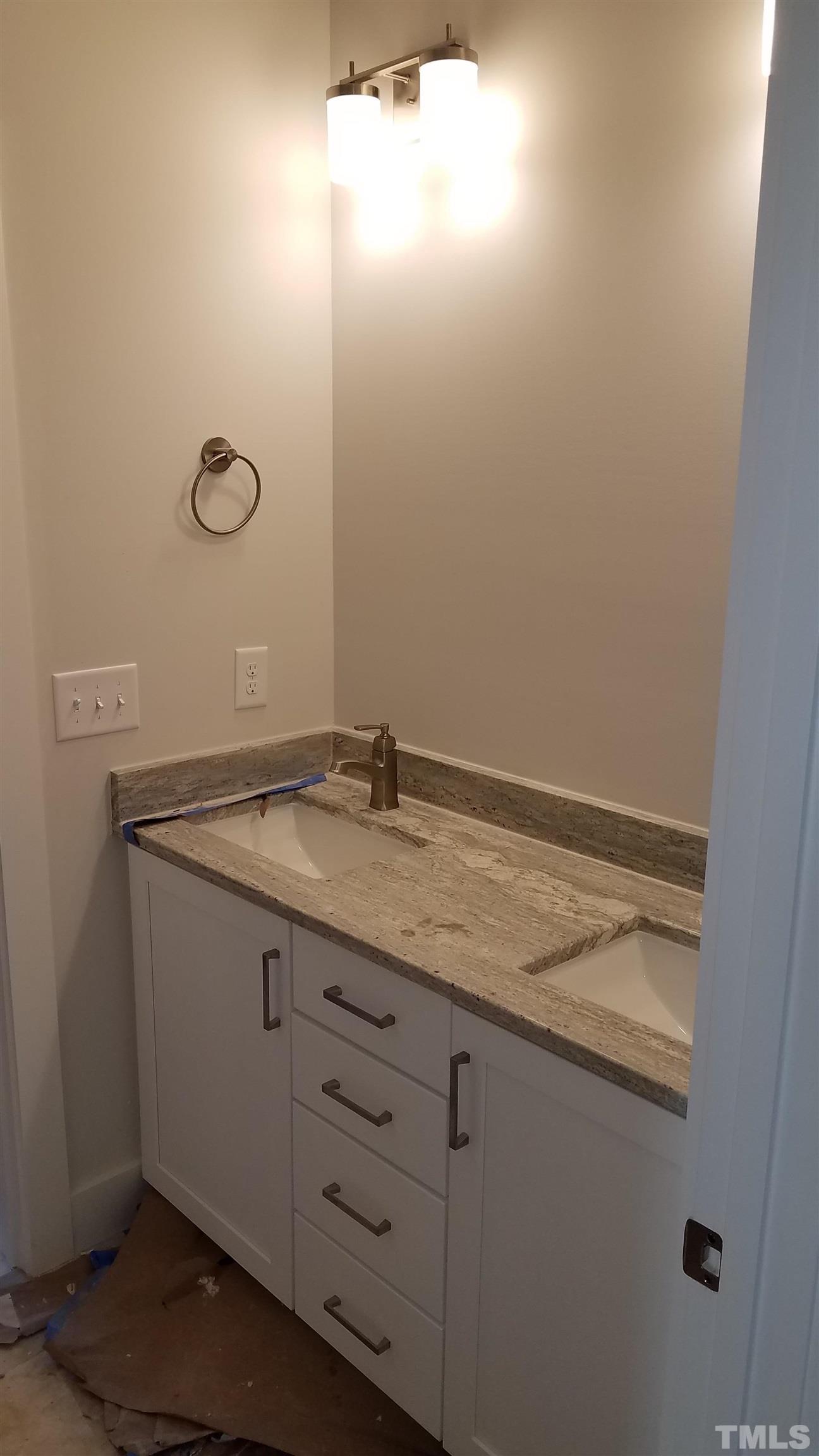 6124 Blanche Drive Raleigh, NC 27607 - Photo 22 of 22 a bathroom with a granite countertop sink and vanity