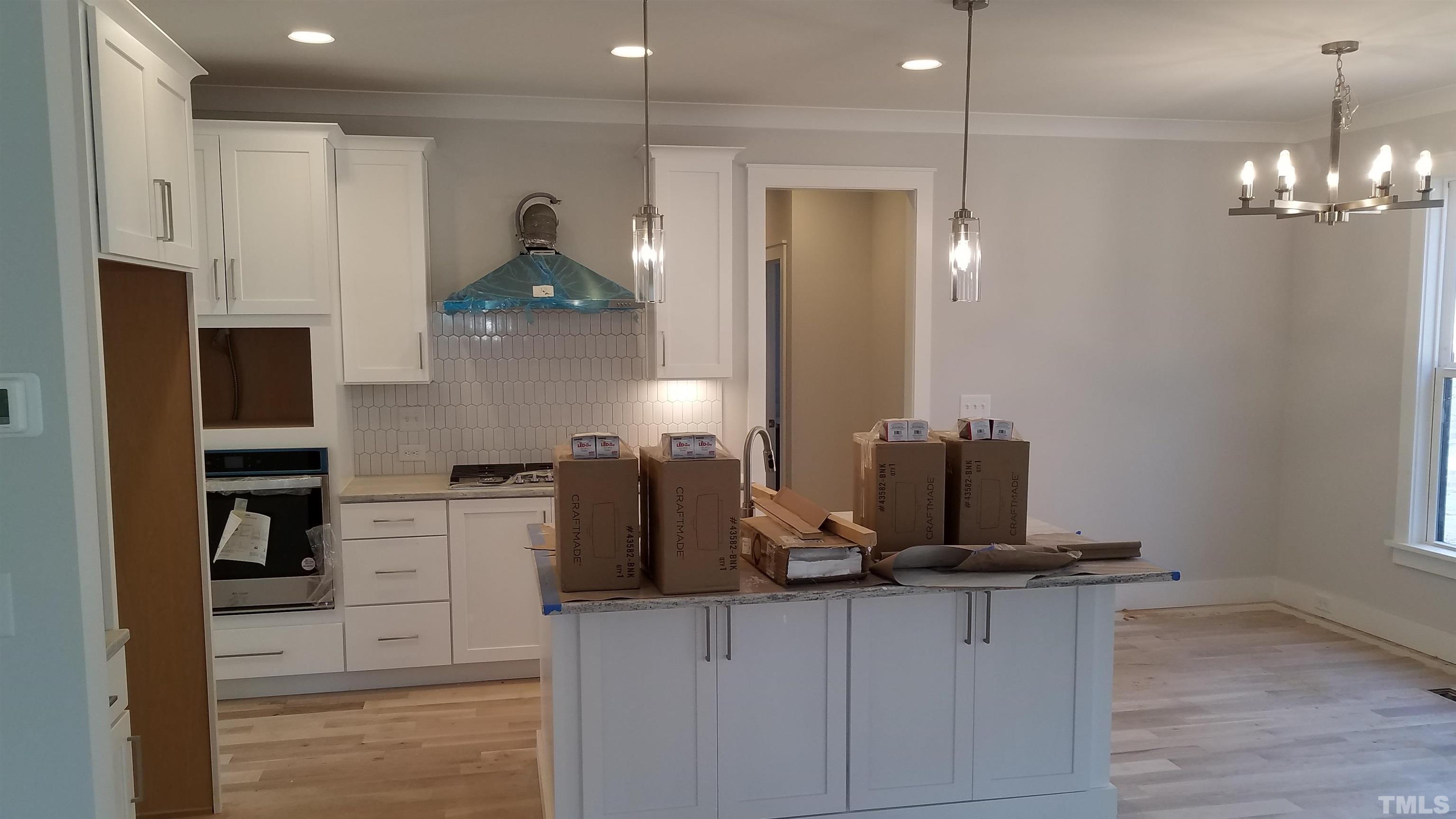 6124 Blanche Drive Raleigh, NC 27607 - Photo 8 of 22 a kitchen with stainless steel appliances granite countertop a sink and a refrigerator