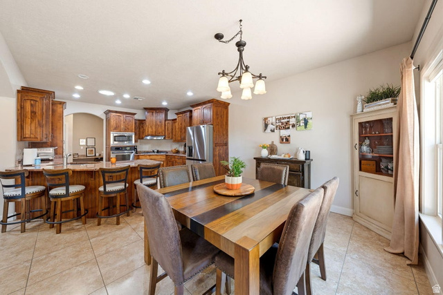 1609 East 10 S Street St. George, UT 84790 - Photo 23 of 68 Open concept kitchen and dining area featuring a breakfast bar with seating, wood-finish cabinetry, stainless steel appliances, and recessed lighting