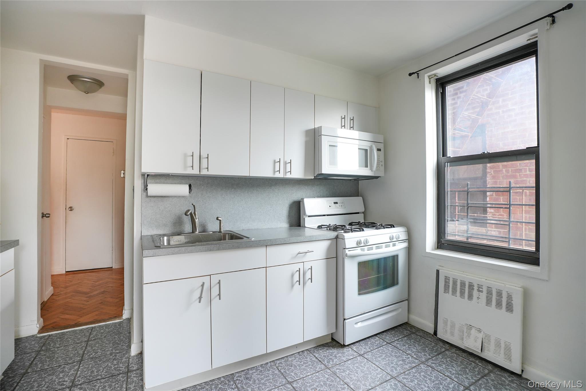 1 Remsen Road, Unit 2F Yonkers, NY 10710 - Photo 8 of 16 a kitchen with stainless steel appliances granite countertop a stove a sink and a microwave