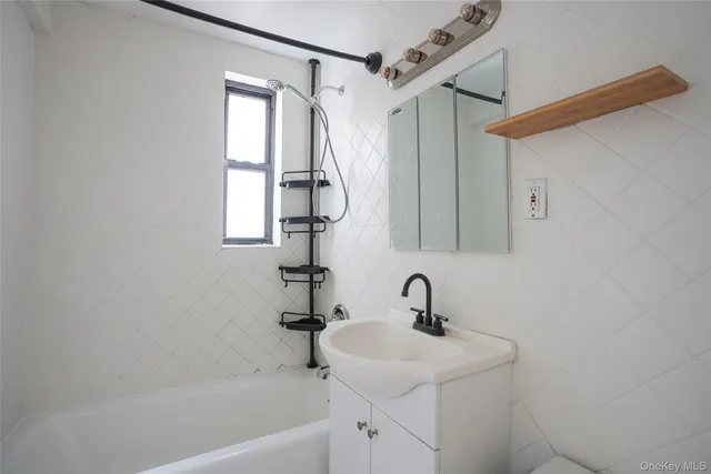 a bathroom with a sink a mirror and a bathtub