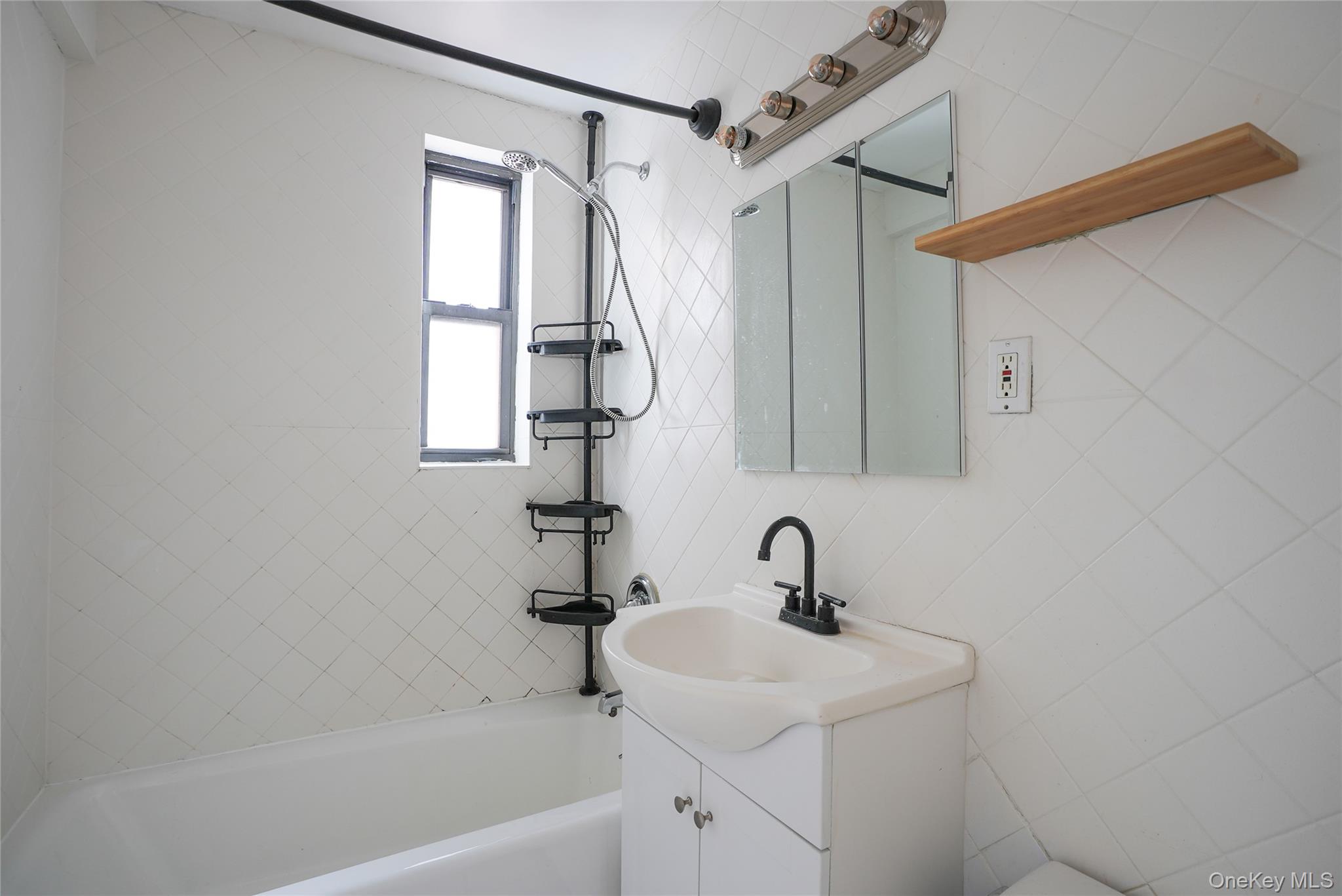 1 Remsen Road, Unit 2F Yonkers, NY 10710 - Photo 9 of 16 a bathroom with a sink a mirror and a bathtub