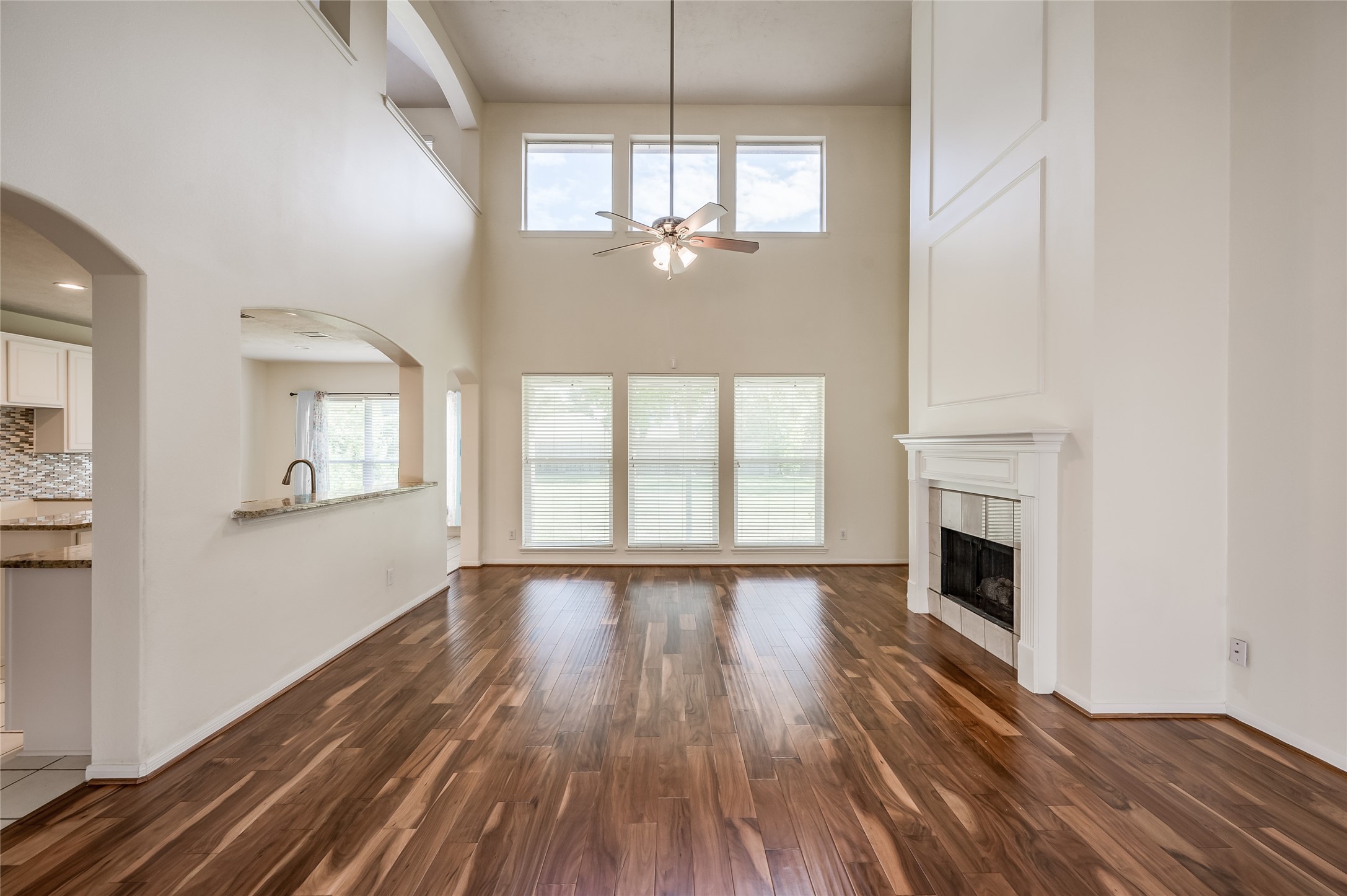 3402 Caloway Court Missouri City, TX 77459 - Photo 2 of 31 a view of an empty room with wooden floor and a window