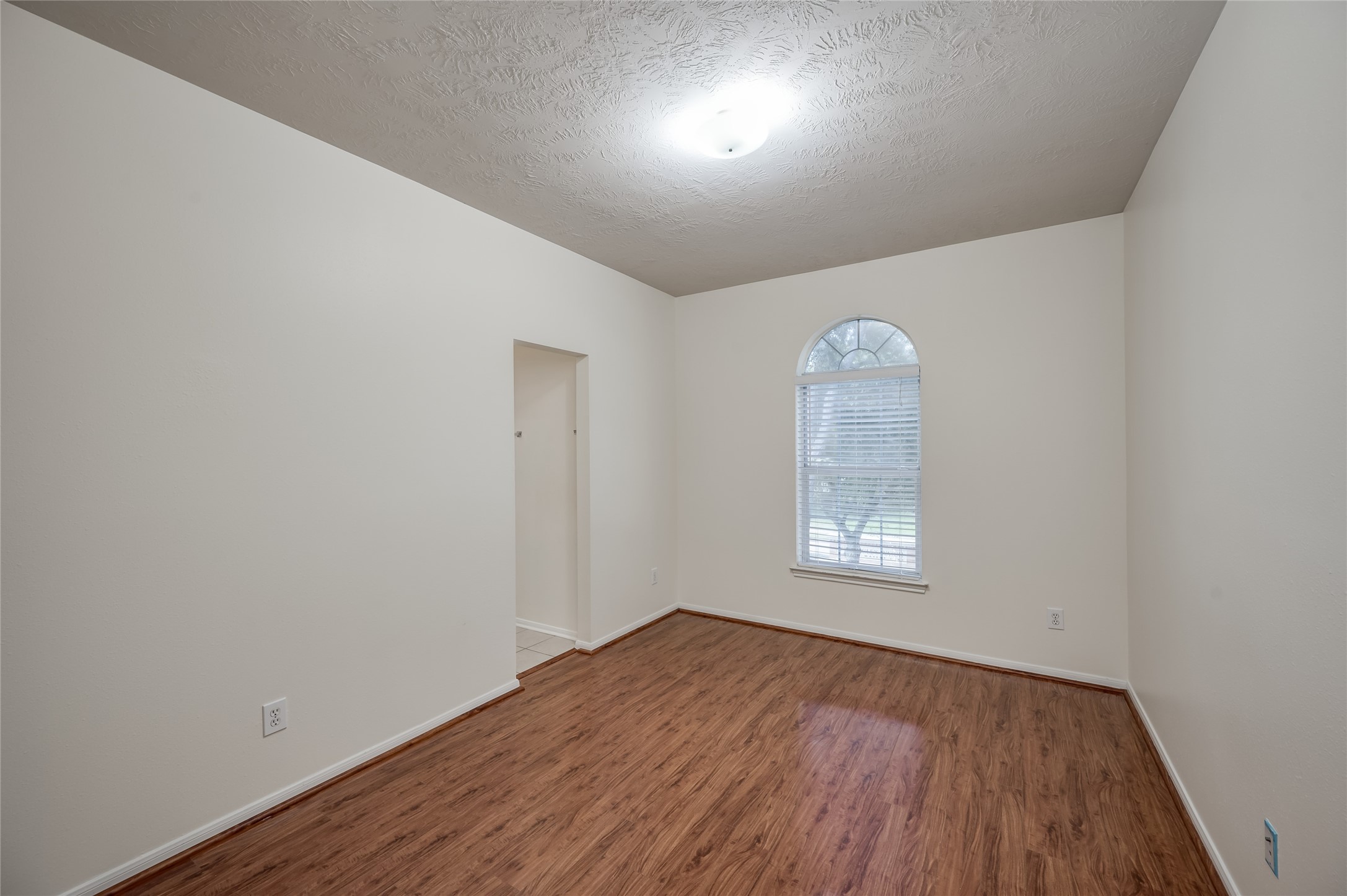 3402 Caloway Court Missouri City, TX 77459 - Photo 23 of 31 an empty room with wooden floor and windows