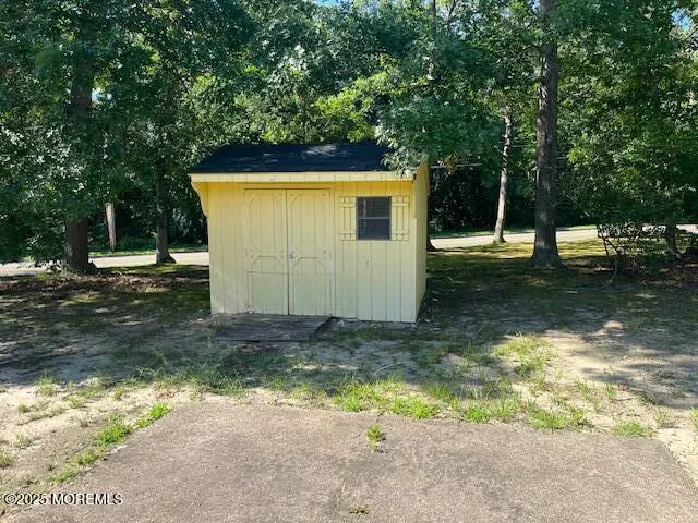 a view of a backyard with large tree