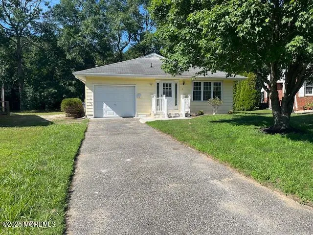 a front view of a house with a garden and yard