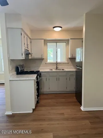 a kitchen with a sink cabinets and window