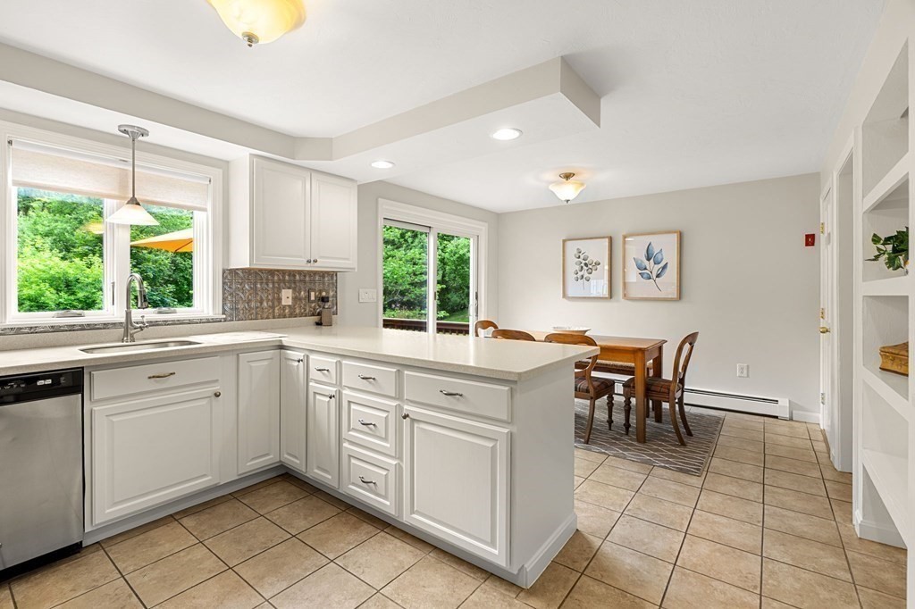 82 Curtis Street Auburn, MA 01501 - Photo 11 of 35 a kitchen with a sink and chairs