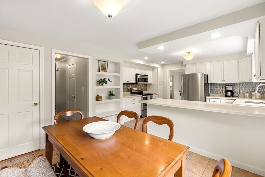 82 Curtis Street Auburn, MA 01501 - Photo 13 of 35 a kitchen with kitchen island granite countertop stainless steel appliances stove refrigerator and cabinets