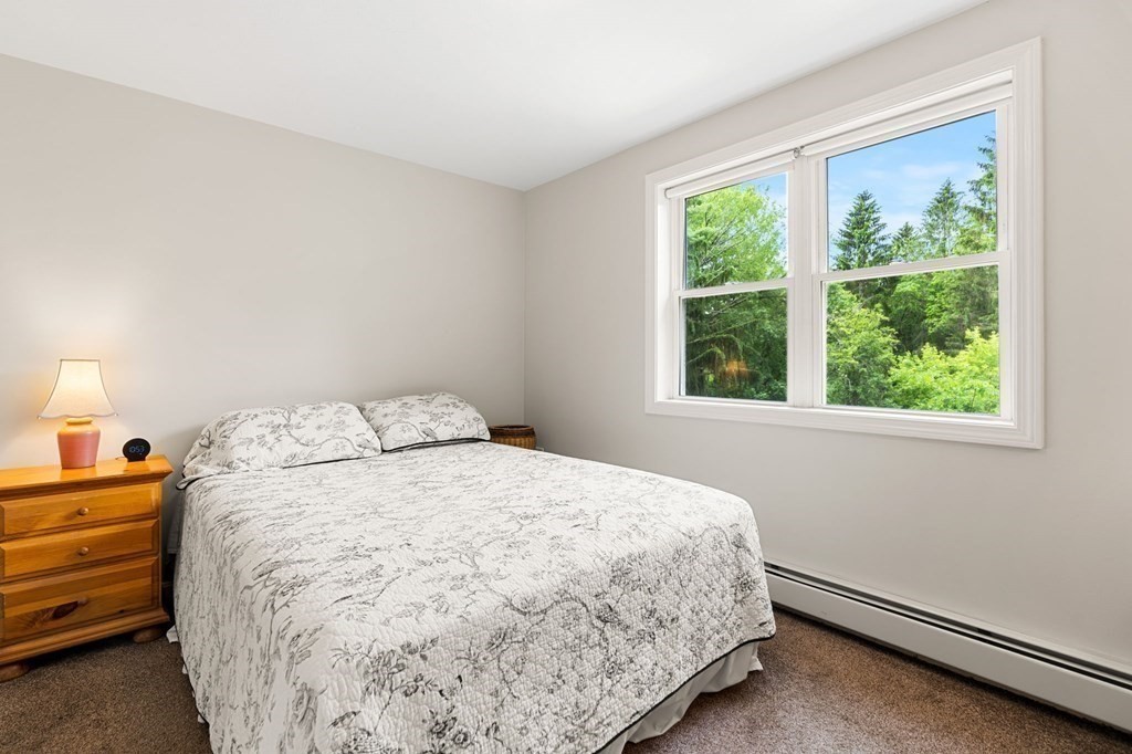 82 Curtis Street Auburn, MA 01501 - Photo 21 of 35 a large bed sitting in a bedroom next to a window