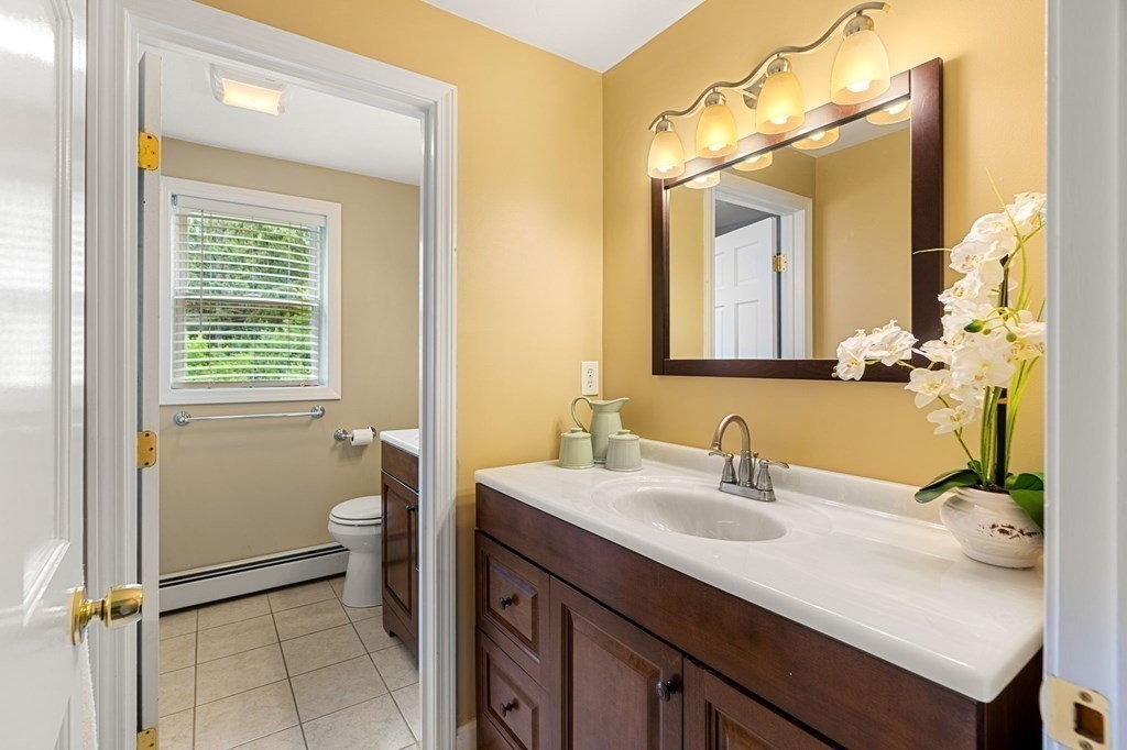 82 Curtis Street Auburn, MA 01501 - Photo 22 of 35 a bathroom with a sink a toilet and mirror