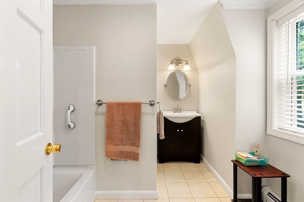 82 Curtis Street Auburn, MA 01501 - Photo 29 of 35 a bathroom with a bathtub sink and mirror