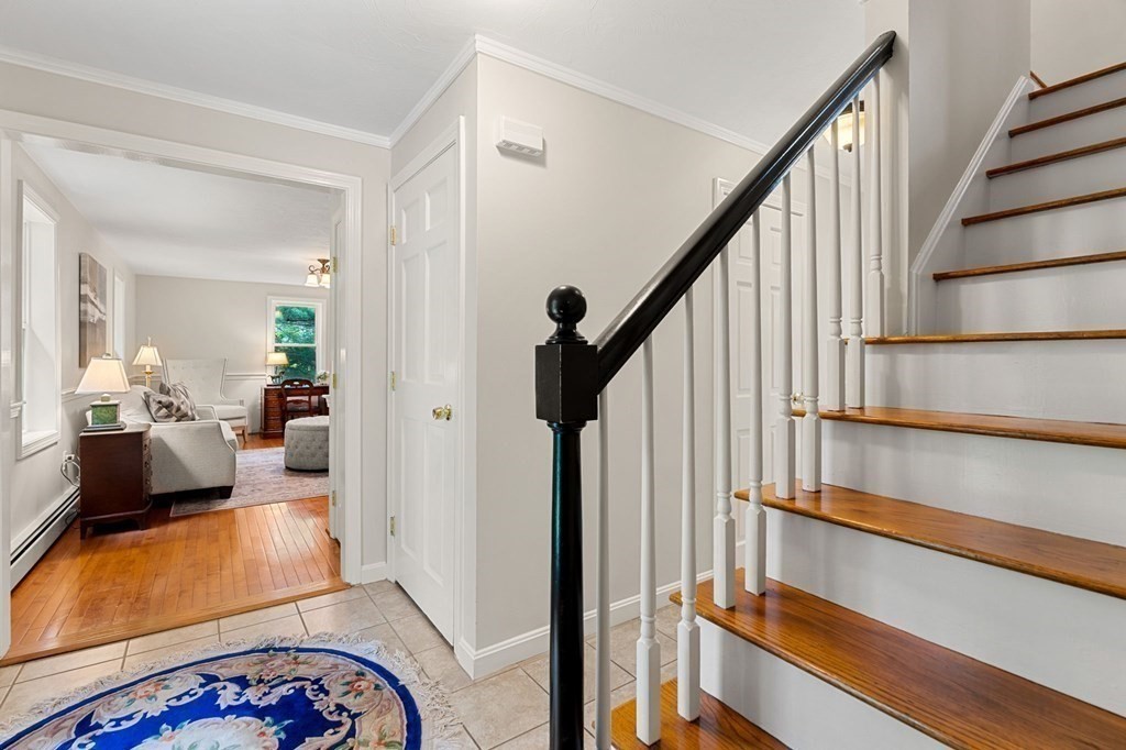 82 Curtis Street Auburn, MA 01501 - Photo 3 of 35 a view of a bedroom with wooden floor and furniture