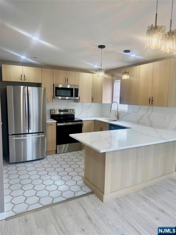 239 40th, Unit 7 Irvington, NJ 07111 - Photo 2 of 8 a kitchen with stainless steel appliances a refrigerator a stove a sink a oven with a dining table and chairs