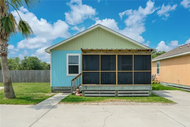a view of house with backyard and garden