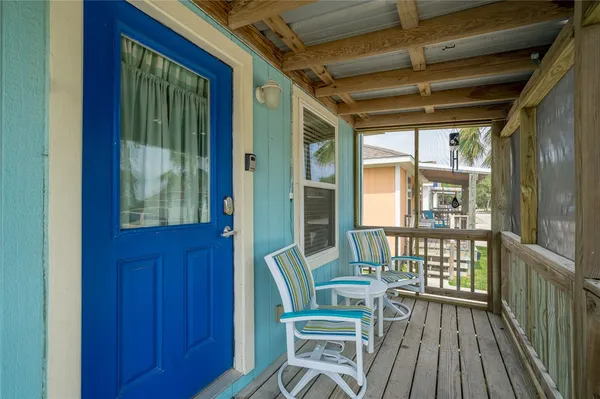 a view of a room with wooden floor and windows