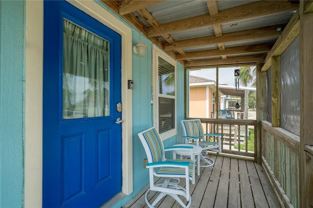 a view of a room with wooden floor and windows