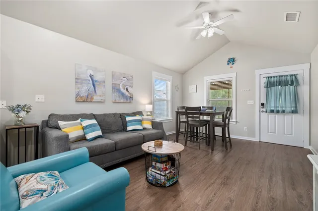 a living room with furniture and wooden floor