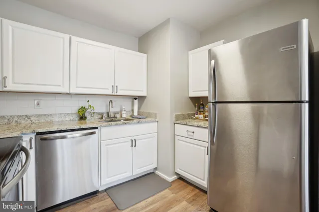 a kitchen with appliances cabinets and a counter top space