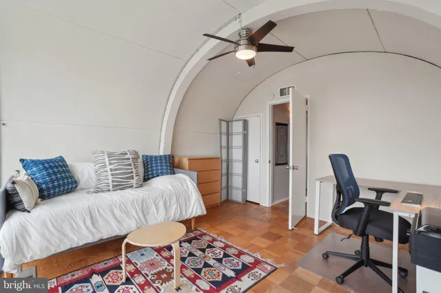 a bedroom with furniture and a rug