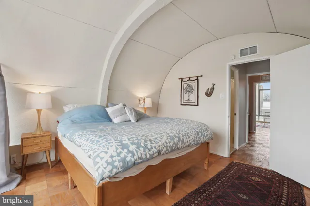 a bedroom with a bed and a lamp