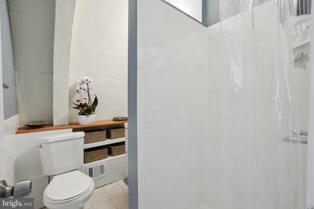 a white toilet sitting next to a bathroom sink