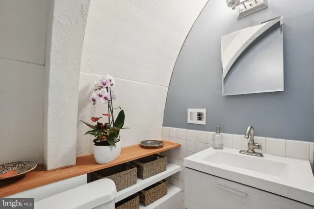 a dining room with table and flowerpot