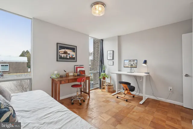 a bed room with a bed and a chair