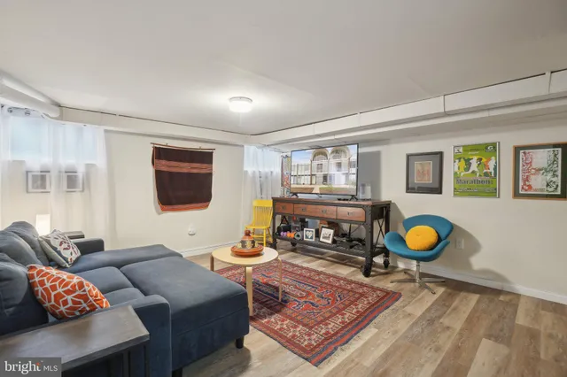 a living room with furniture and a rug