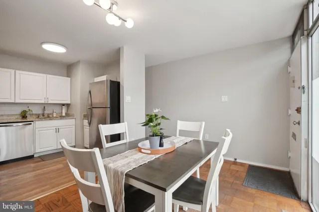 a dining room with furniture and wooden floor