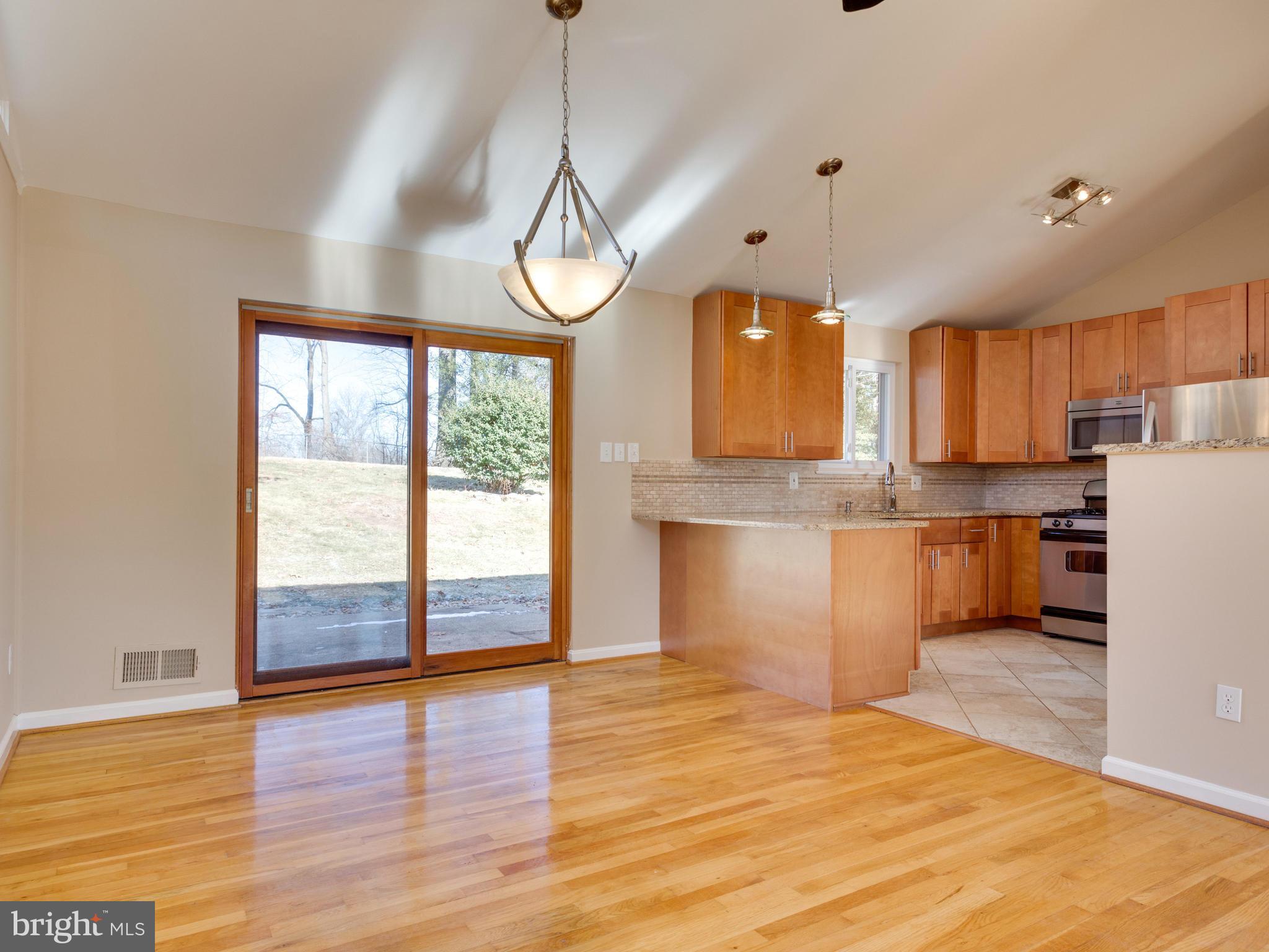 8702 Victoria Road Springfield, VA 22151 - Photo 5 of 27 a view of a kitchen with wooden floor and a window