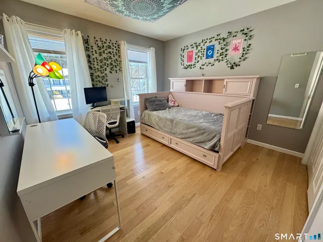 a bedroom with furniture and a window