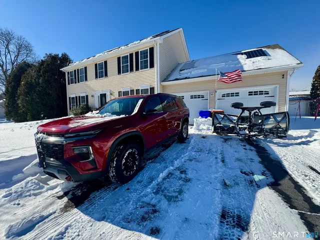 a car is parked in front of a house
