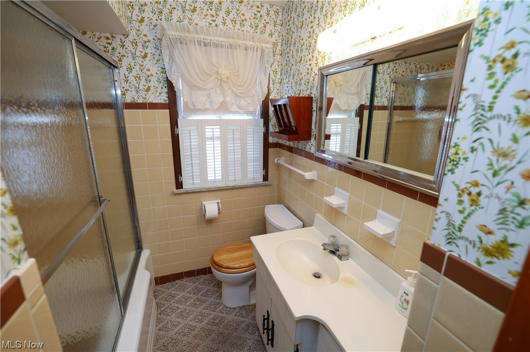 29252 Barjode Road Willowick, OH 44095 - Photo 11 of 21 Full bathroom with tile walls, tile flooring, large vanity, tasteful backsplash, and toilet