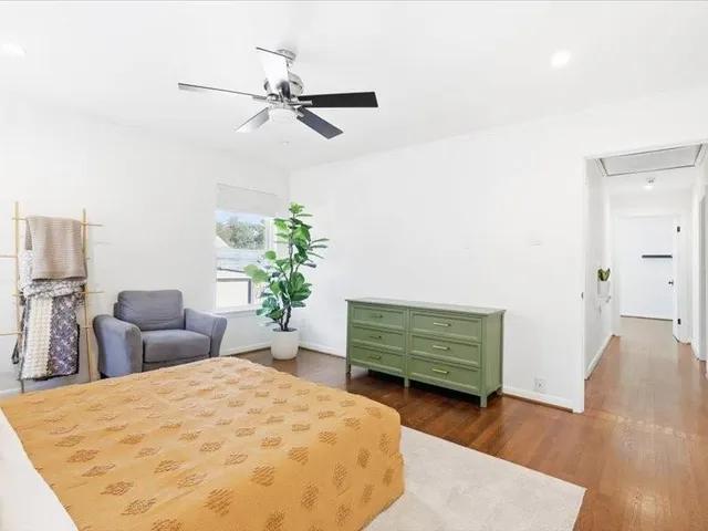 a bedroom with furniture and a potted plant