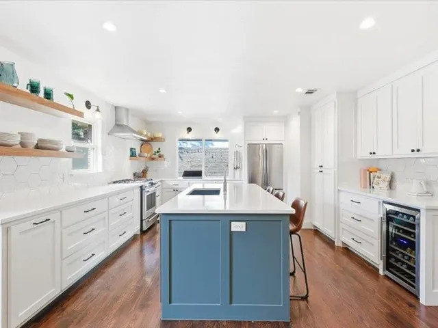 a kitchen with counter top space sink and cabinets