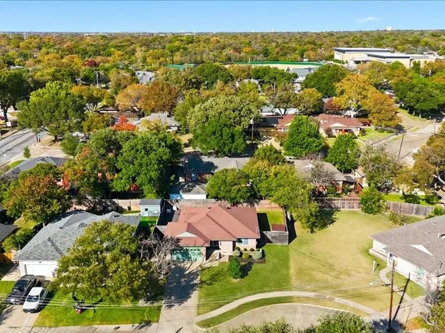 an aerial view of residential houses with outdoor space