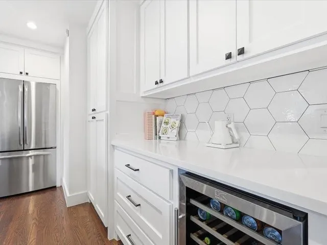 a kitchen with stainless steel appliances a refrigerator and cabinets