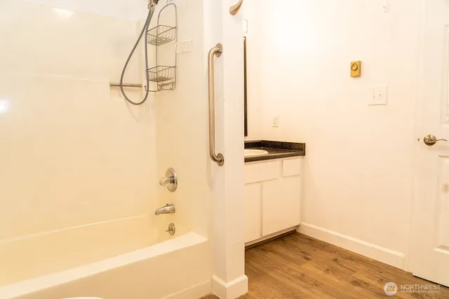 a bathroom with a bathtub and a shower
