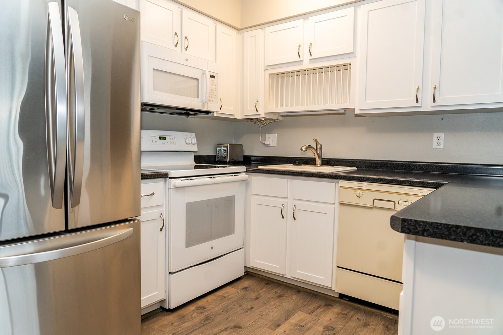 2005 Tibbetts Drive, Unit 305 Longview, WA 98632 - Photo 6 of 16 a kitchen with stainless steel appliances granite countertop a refrigerator sink and cabinets