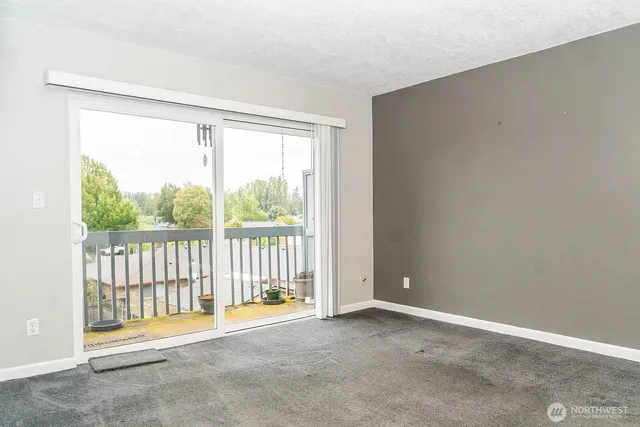a view of an empty room with a balcony