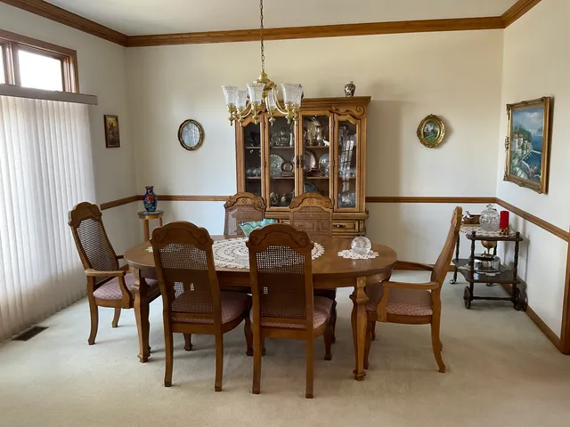 a view of a dining room with furniture and chandelier