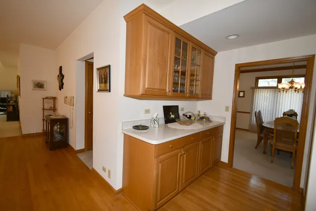 a kitchen with stainless steel appliances granite countertop a stove a sink dishwasher and a refrigerator with wooden floor