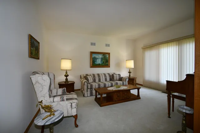 a living room with furniture wall and a large window