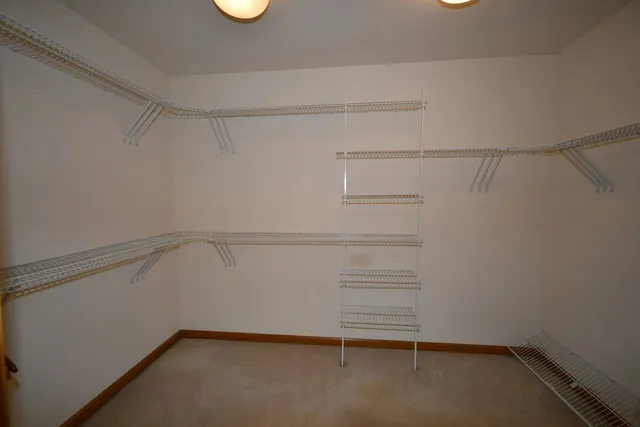 a bathroom with a double vanity sink a toilet a mirror and shower