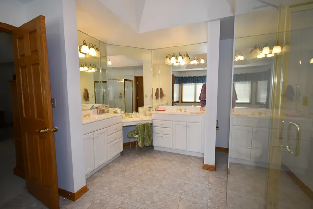 a bathroom with a sink mirror and vanity