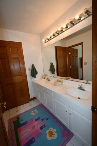 a bathroom with a sink a mirror and shower
