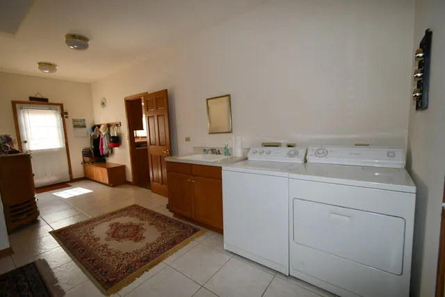 a walk in closet with window and a mirror